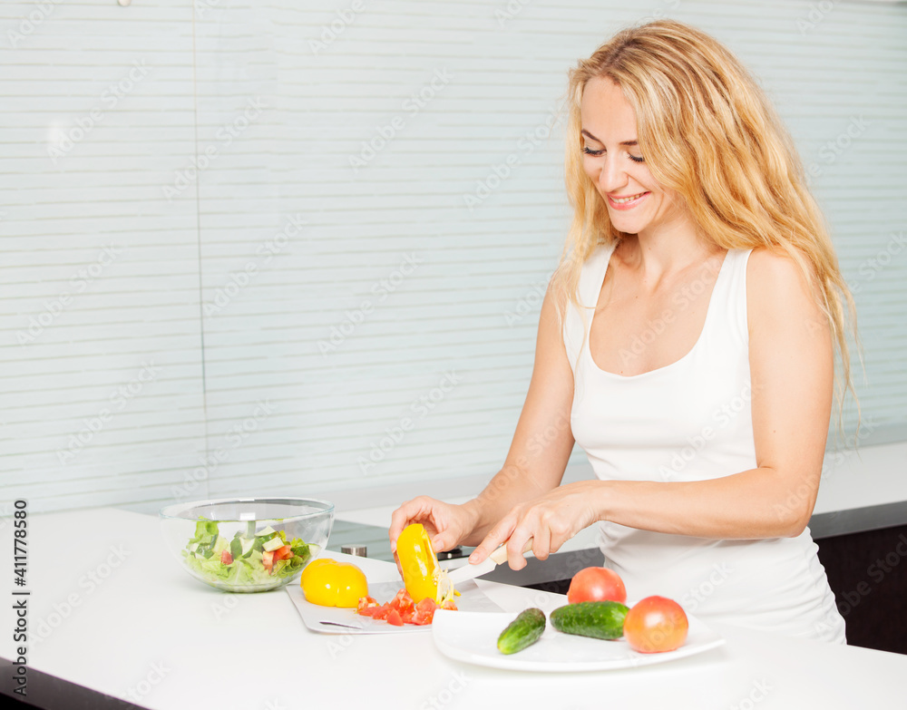 Young woman preparing vegetable salad