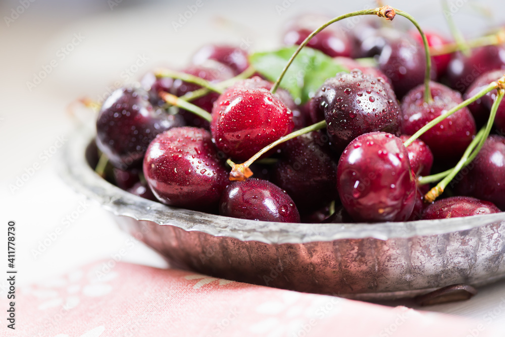 Cherries on wooden table with napkin and water drops macro background Cherries on wooden table with napkin and water drops macro background