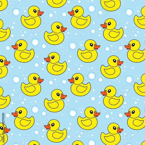 Seamless pattern with yellow rubber ducks and soap bubbles on blue background.