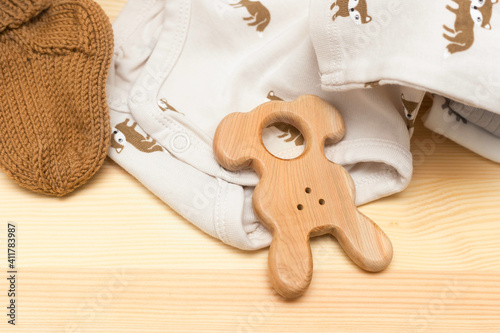 clothes and toys for a newborn on a wooden chest of drawers