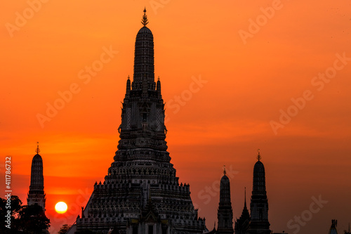 A close-up view of the background of a major tourist attraction in Bangkok of Thailand (Wat Arun Ratchawararam Ratchaworamahawihan) is a large chedi installed on the Chao Phraya River. © bangprik
