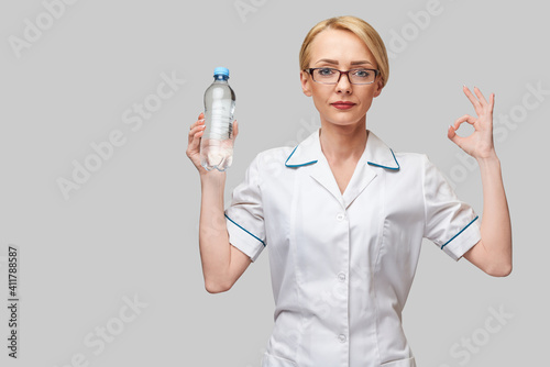 female woman nutritionist or dietician doctor healthy lifestyle concept - holding bottle of water
