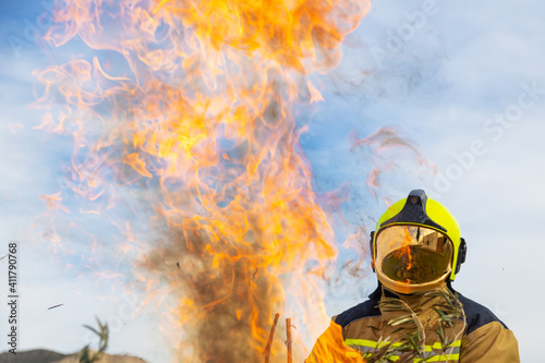 Fototapeta Naklejka Na Ścianę i Meble -  firefighter man in front of fire