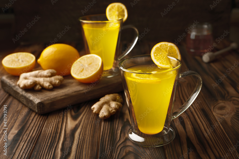 Two glass cup of lemon ginger lemonade and ingredients