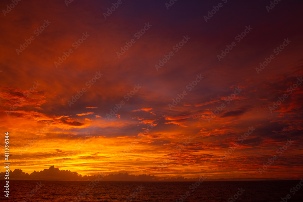 Orange sunset in Pacific Ocean after storm