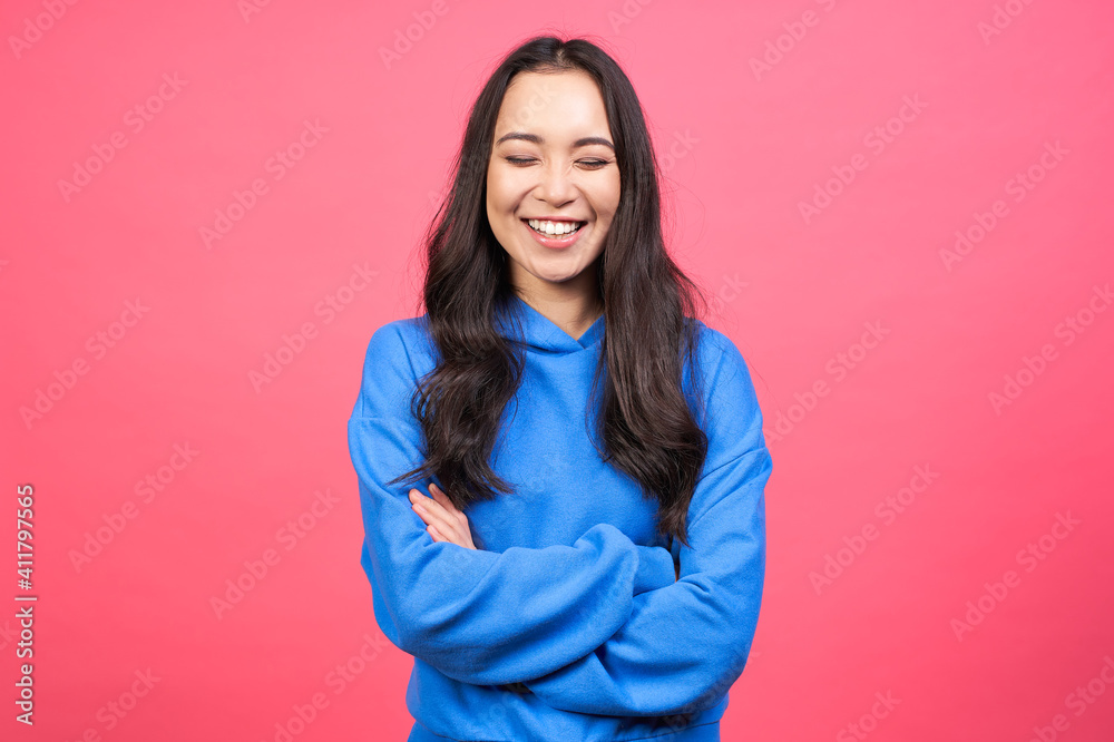 Laughing young Asian lady in blue hoodie. Laughing young Asian lady in blue hoodie.