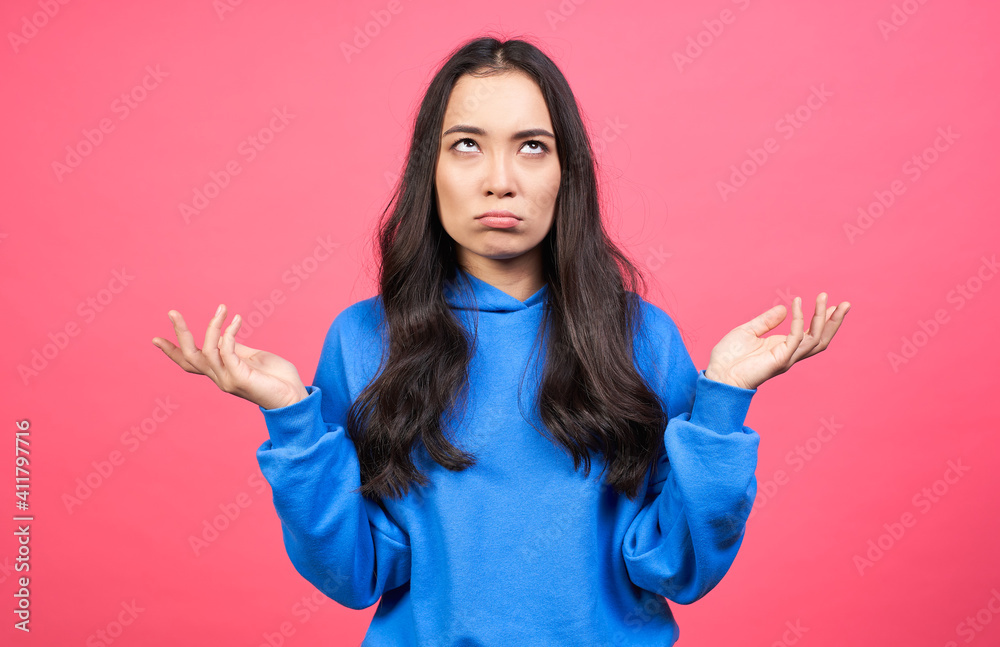 A young Asian girl spread her arms aside in bewilderment. A young Asian girl spread her arms aside in bewilderment.