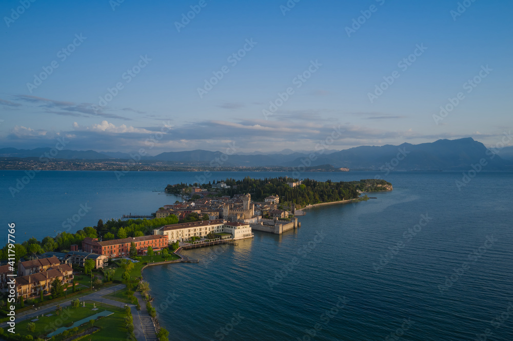 Sirmione city, Italy. Lake Garda. The historic castle of Castello di Sirmione. Blue sky, early morning aerial view