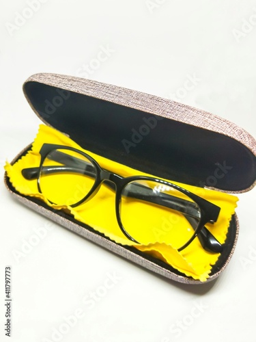 Black anti-radiation glasses are put in the box with a cloth to clean the glasses.