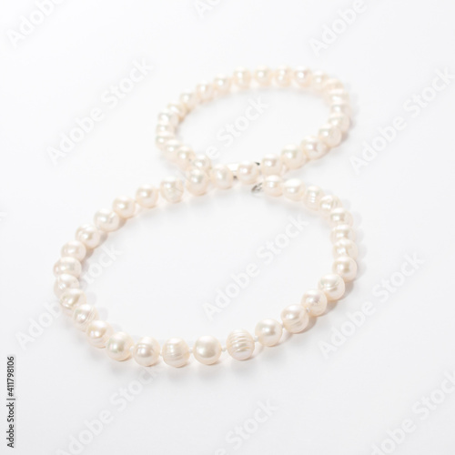 numeral 8 from pearls on white background © Olga Burmistrova