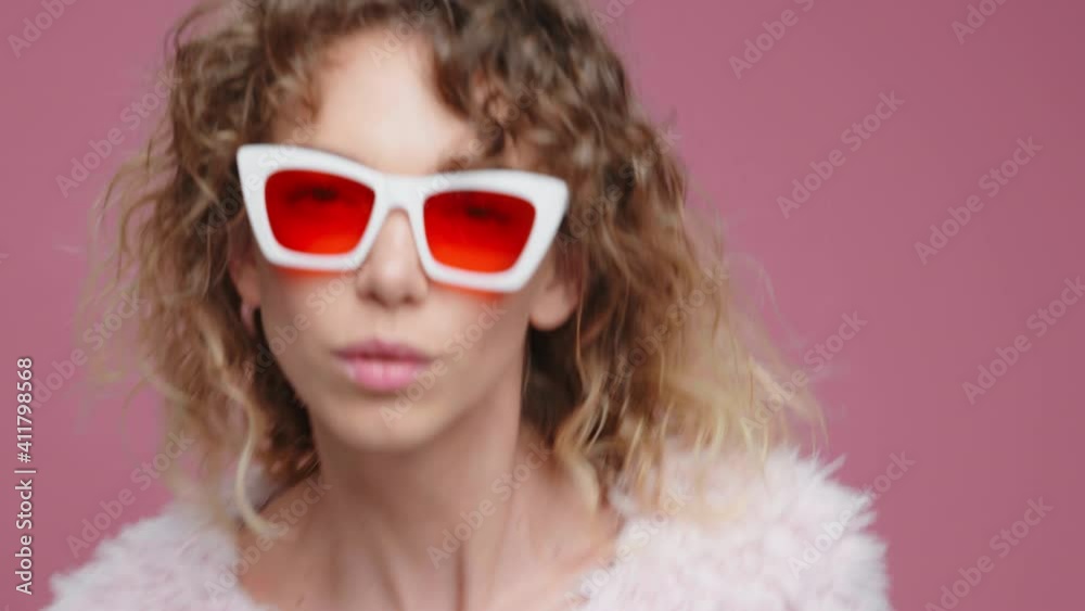Portrait Dancing Glamorous, Beautiful Girl in sunglasses. Dancing Happy Young Woman Moves Rhythmically Looking On Camera to Music Sings Slow Motion on Pink Background. Positive Emotions. Freedom Portrait Dancing Glamorous, Beautiful Girl in sunglasses. Dancing Happy Young Woman Moves Rhythmically Looking On Camera to Music Sings Slow Motion on Pink Background. Positive Emotions. Freedom