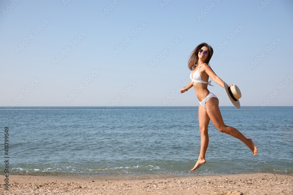 Young woman with beautiful body on beach. Space for text Young woman with beautiful body on beach. Space for text