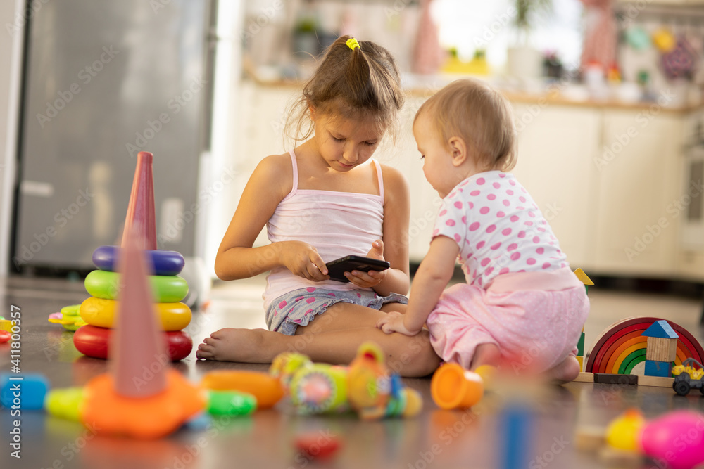 Fototapeta premium Two children play toys