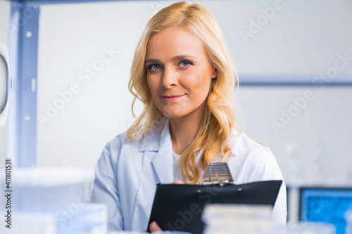 Professional female scientist is working on a vaccine in a modern scientific research laboratory. Genetic engineer workplace. Future technology and science.