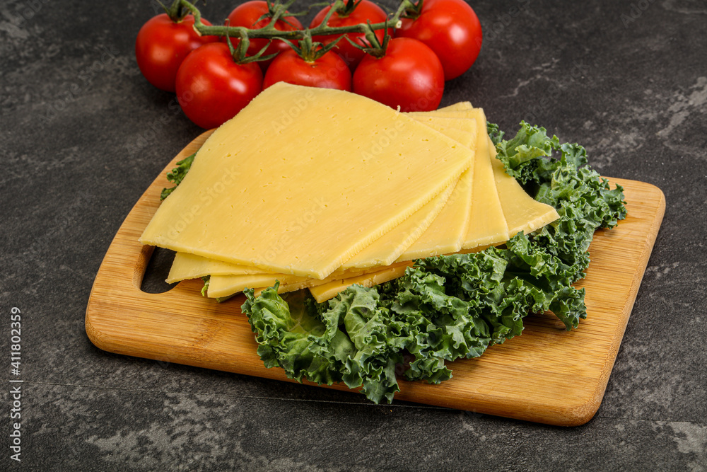 Sliced Gauda cheese over board Sliced Gauda cheese over board