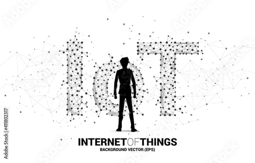 Silhouette of businessman standing and Polygon dot connect line shaped IoT wording . Concept for telecommunication and internet of things. © Panithan