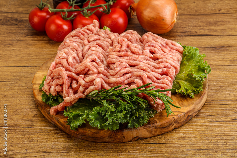 Raw pork minced meat over board