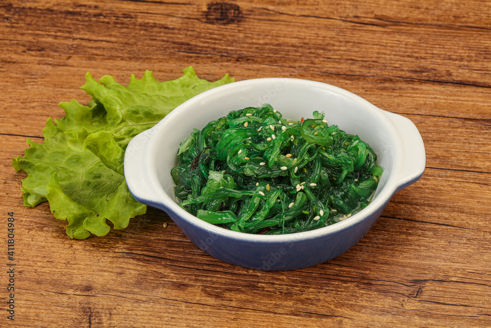 Green Chuka Seaweed Salad Isolated on White Background Top View. Wakame Sea Kelp Salat Green Chuka Seaweed Salad Isolated on White Background Top View. Wakame Sea Kelp Salat