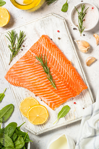 Salmon fillet with ingresients for cooking. Raw fish. Top view at white table.