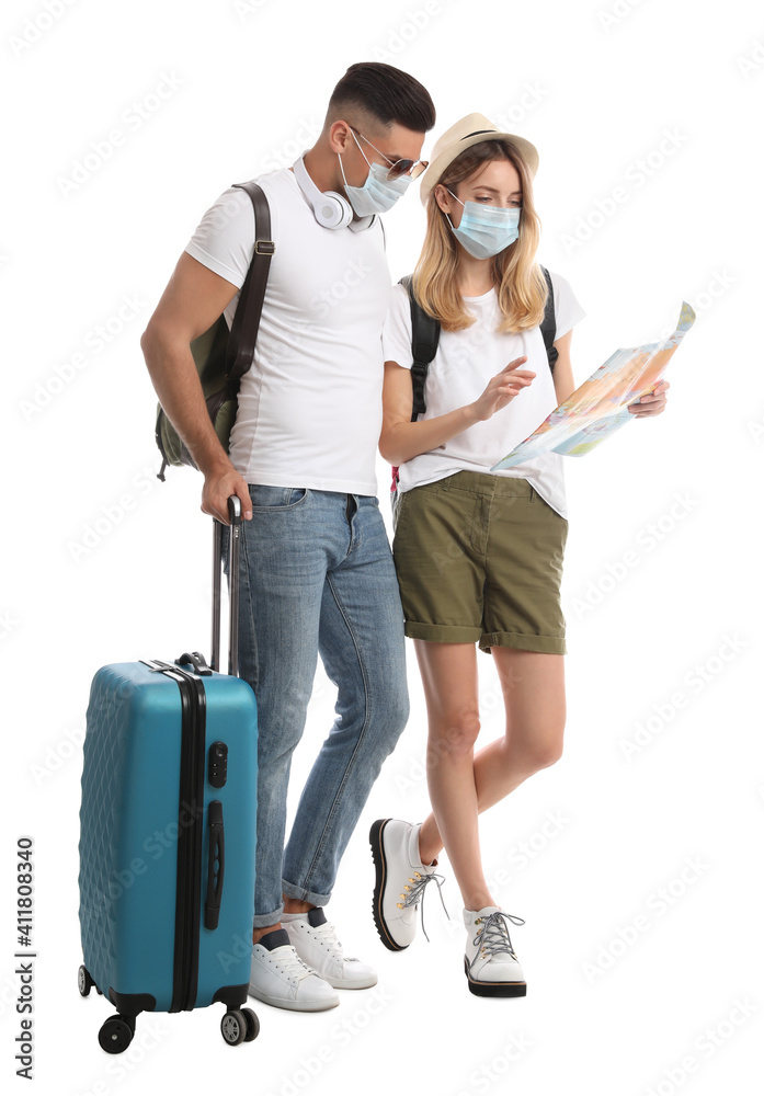 Couple in face masks with map on white background. Summer travel Couple in face masks with map on white background. Summer travel
