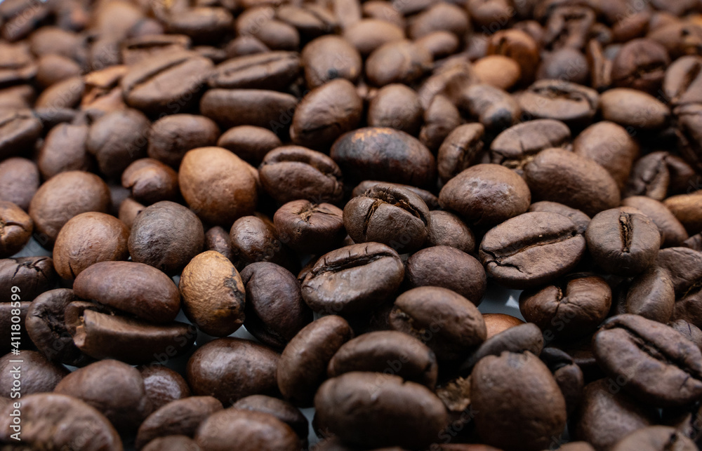 Background image with roasted brown coffee beans Background image with roasted brown coffee beans