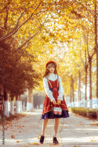 A girl in a skirt in the autumn sun