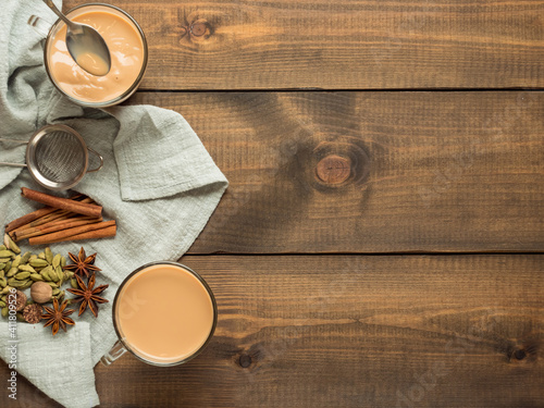 Photography Two mugs with masala tea stand on a wooden table with spices