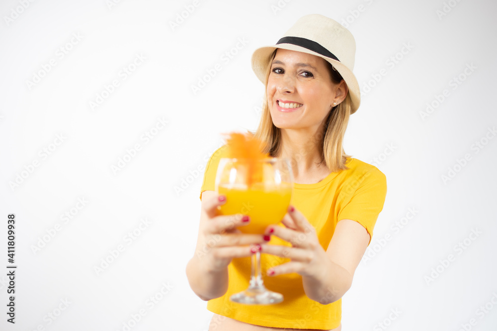 Beautiful young blonde woman in yellow t-shirt drinking orange juice in a summer day. Healthy organic drinks concept. People on a diet. Beautiful young blonde woman in yellow t-shirt drinking orange juice in a summer day. Healthy organic drinks concept. People on a diet.