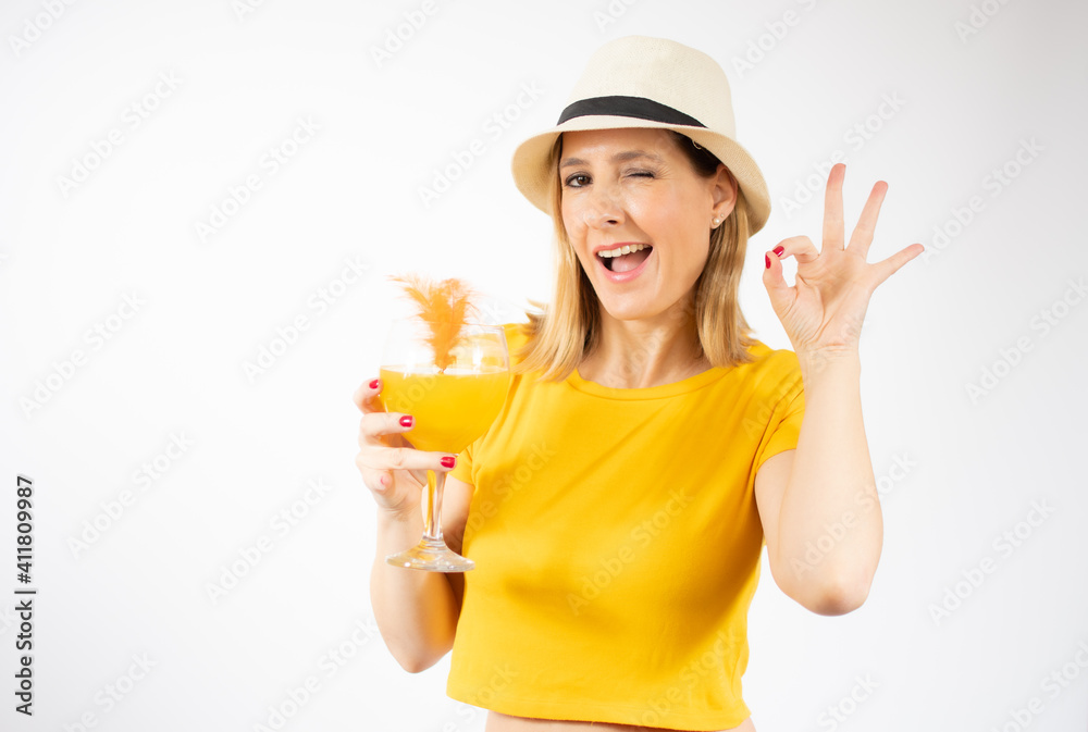 Beautiful young blonde woman in yellow t-shirt drinking orange juice in a summer day. Healthy organic drinks concept. People on a diet. Beautiful young blonde woman in yellow t-shirt drinking orange juice in a summer day. Healthy organic drinks concept. People on a diet.