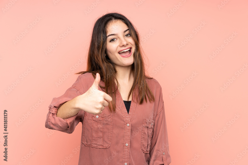 Young caucasian woman isolated on pink background with thumbs up because something good has happened Young caucasian woman isolated on pink background with thumbs up because something good has happened