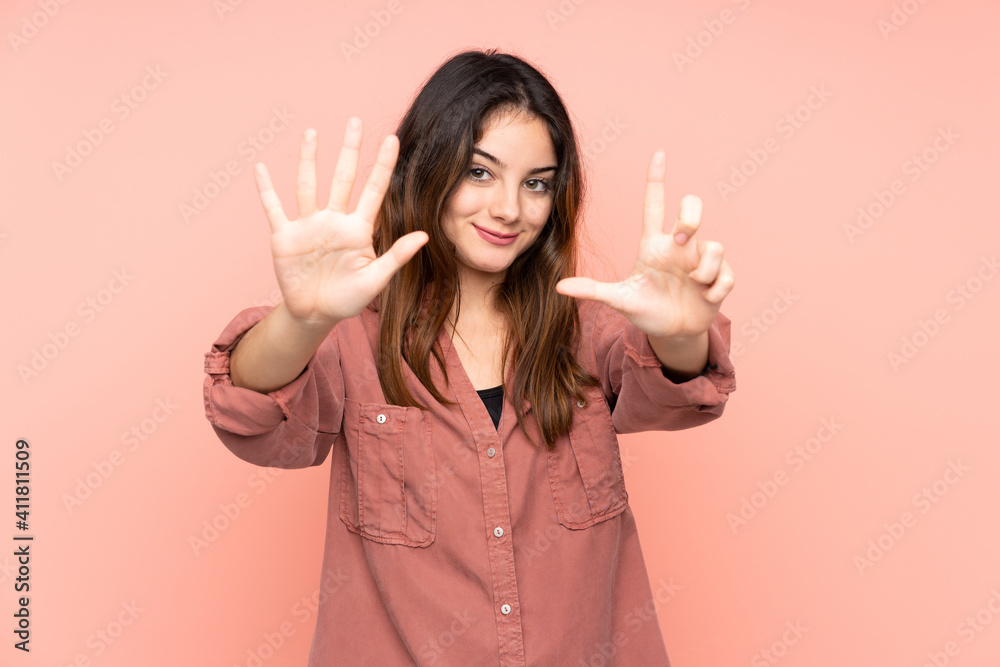 Young caucasian woman isolated on pink background counting seven with fingers
