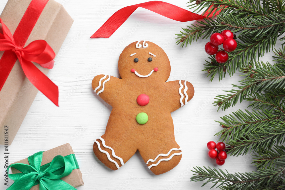 Flat lay composition with gingerbread man and Christmas decor on white wooden table Flat lay composition with gingerbread man and Christmas decor on white wooden table