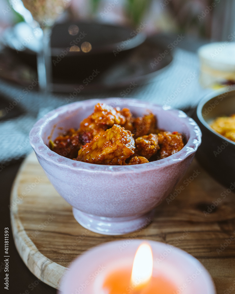 Delicious Indonesian take away foods hold in hands, rendang, beans, shrimps, crisps, tofu, rice, bami, restaurant in the Netherlands Delicious Indonesian take away foods hold in hands, rendang, beans, shrimps, crisps, tofu, rice, bami, restaurant in the Netherlands