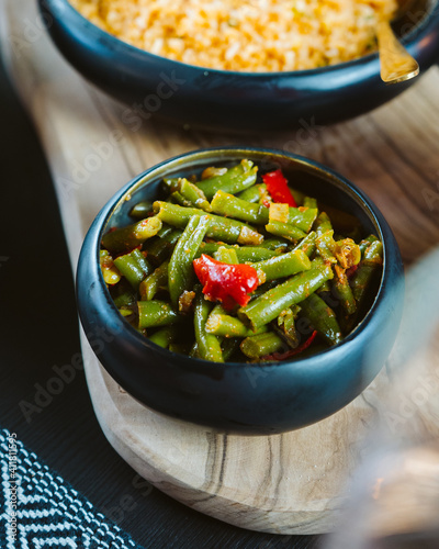 Delicious Indonesian take away foods hold in hands, rendang, beans, shrimps, crisps, tofu, rice, bami, restaurant in the Netherlands