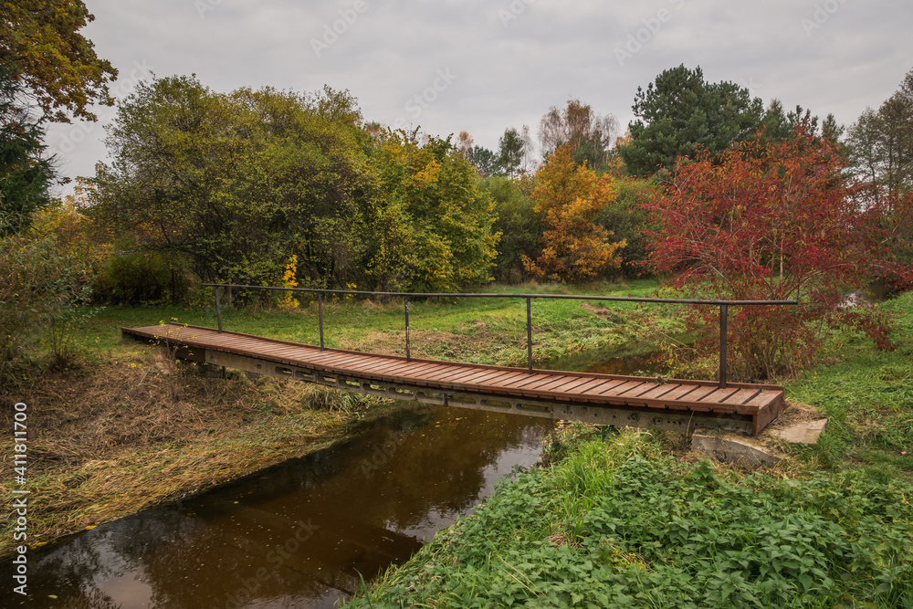 Footbridge over the Czarna river at autumn near Gora Kalwaria, Mazowieckie, Poland