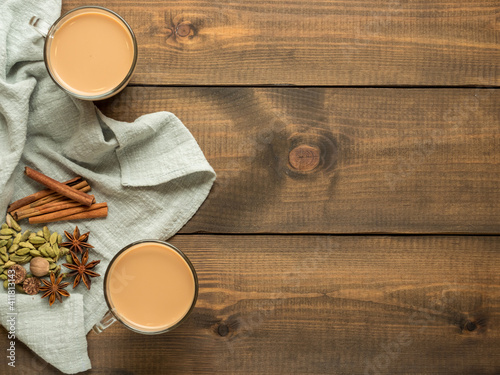 Photography Spices for masala tea lie on a fabric, on a wooden table Top view