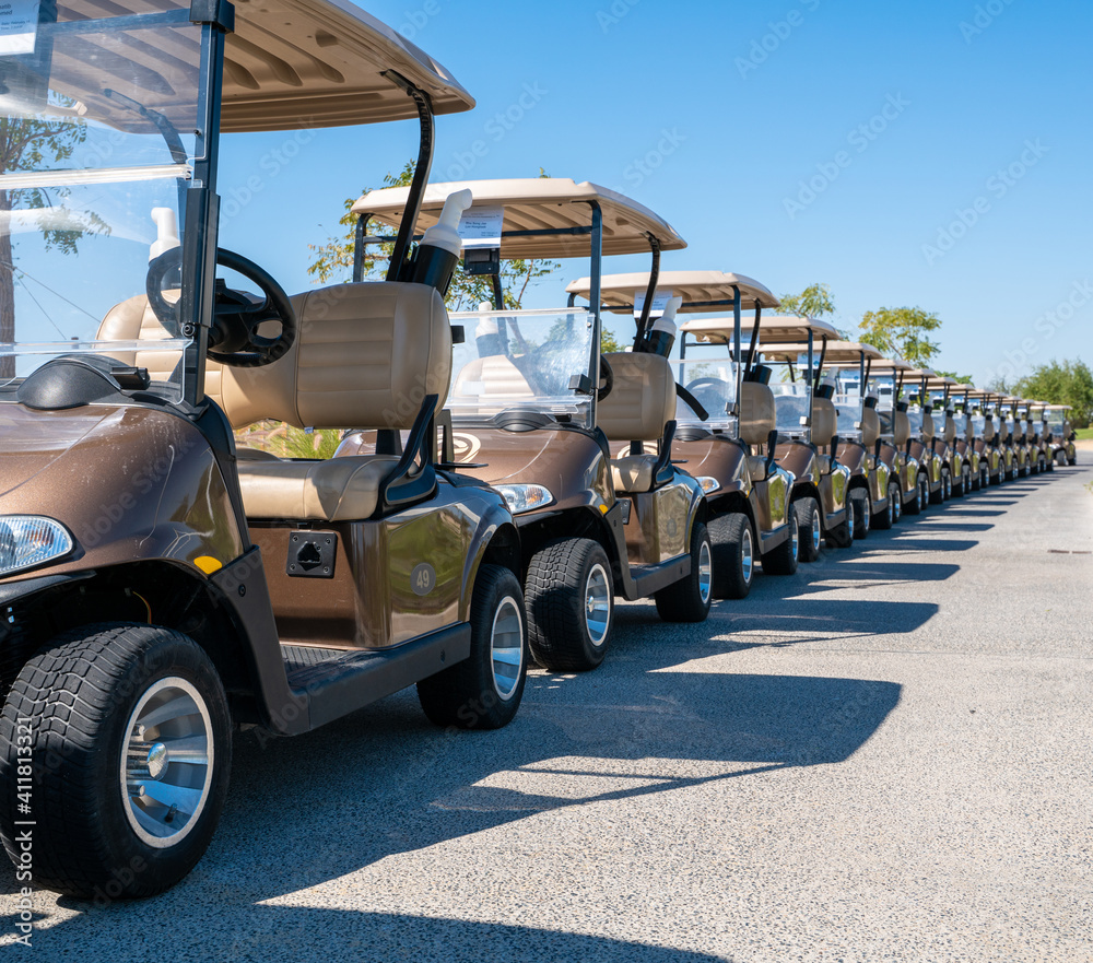Background image of multiple golf carts parked in order.