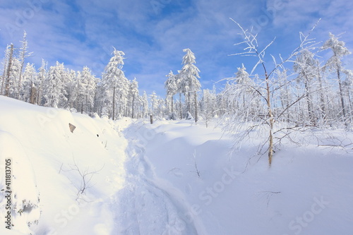 Snowfall in Poland. Snow-covered Beskid mountains against the background of blue sky. Winter in Poland.
