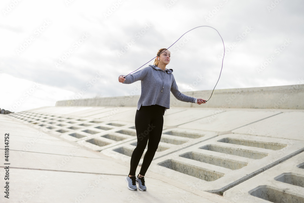 Sport fit woman jumping rope outdoors. Healthy lifestyle Sport fit woman jumping rope outdoors. Healthy lifestyle