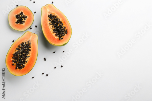 Fresh ripe papaya fruits on white background, flat lay. Space for text photo