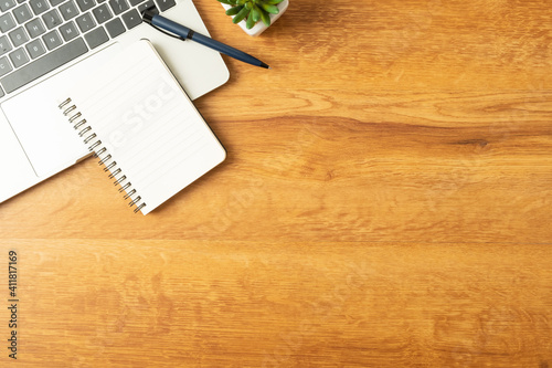 Workplace of office desk wooden table with laptop, and equipment other office supplies with copy space, flat lay