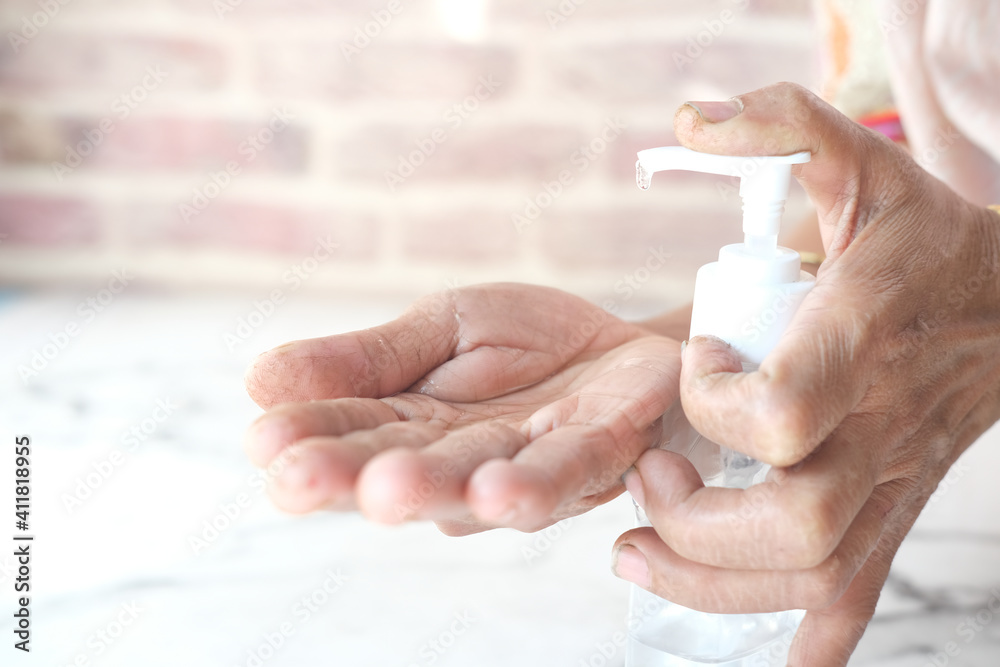 close up of senior women hand using sanitizer gel for preventing virus close up of senior women hand using sanitizer gel for preventing virus