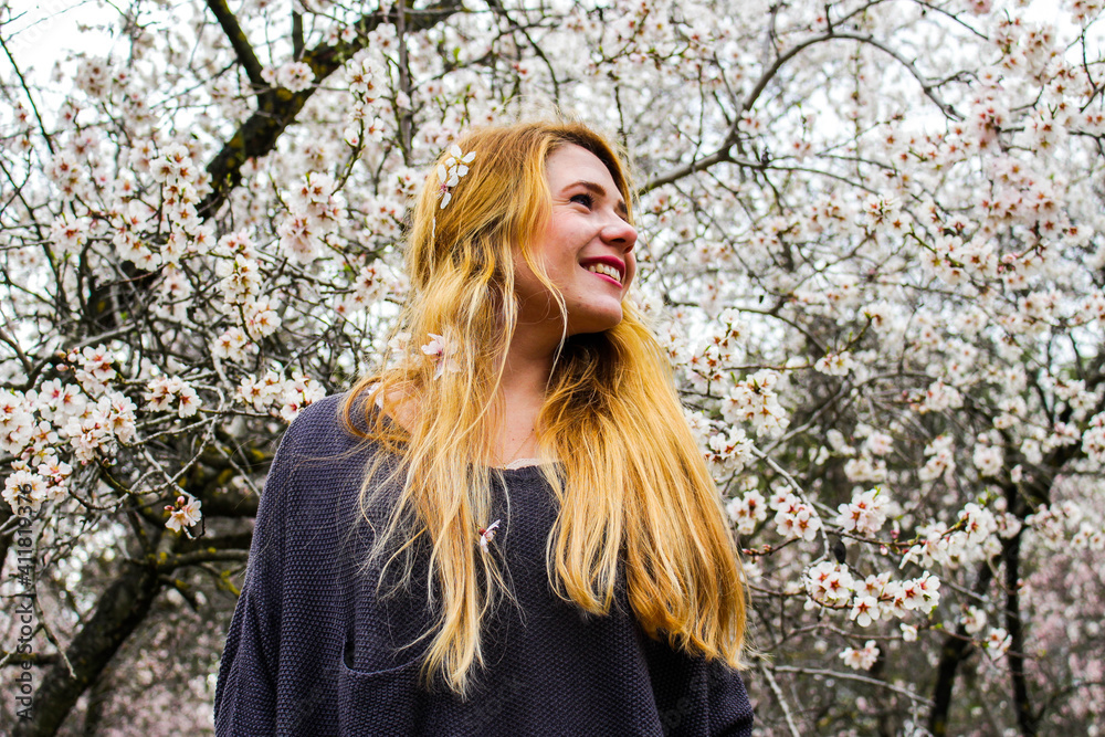 Beautiful young blonde woman with flowers outside Beautiful young blonde woman with flowers outside
