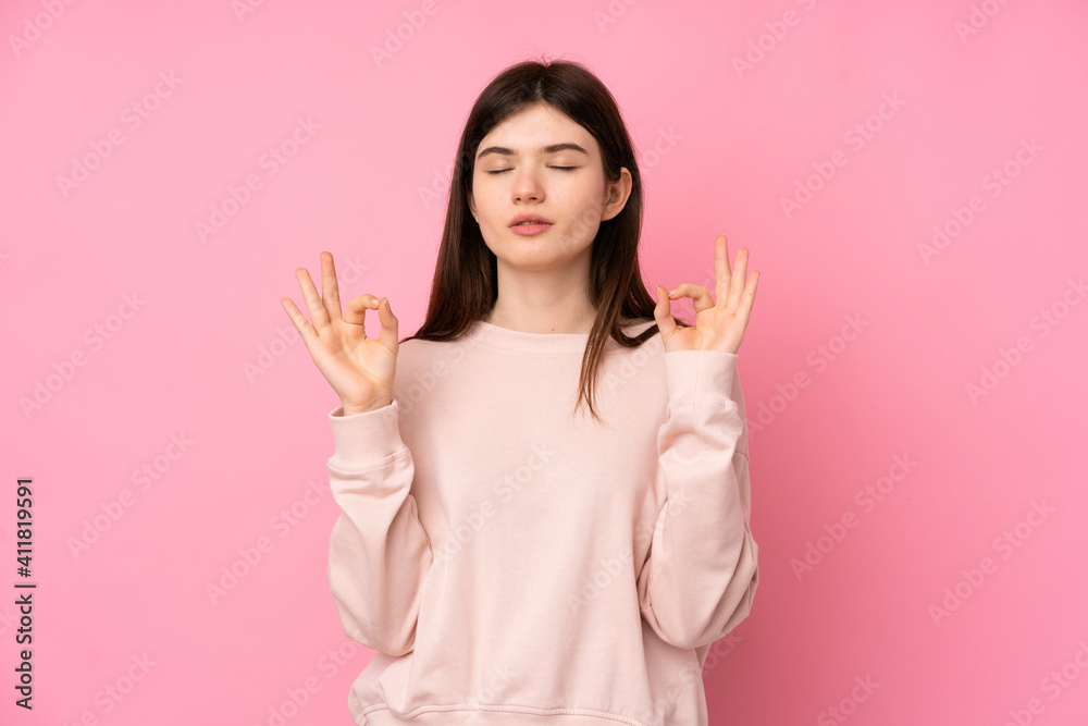 Young Ukrainian teenager girl over isolated pink background in zen pose Young Ukrainian teenager girl over isolated pink background in zen pose