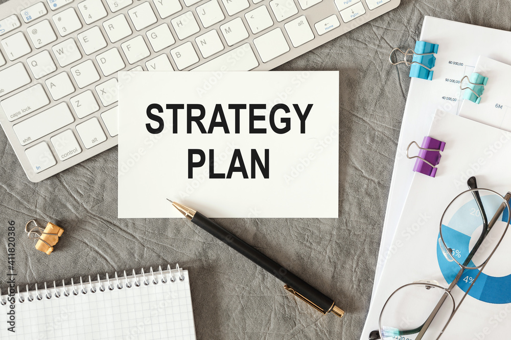 STRATEGY PLAN is written in a document on the office desk STRATEGY PLAN is written in a document on the office desk