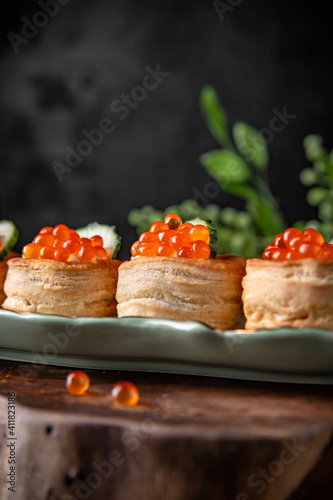 Tartlets or canapes with butter and red caviar. Gourmet food, appetizer. Delicatessen. Seafood