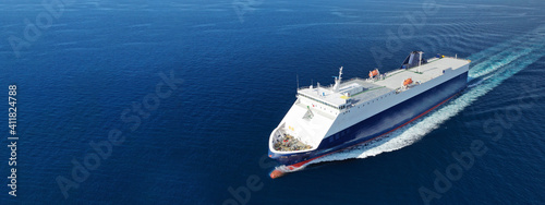 Photo Aerial drone ultra wide photo of large RoRo (Roll on-off) vessel cruising the At