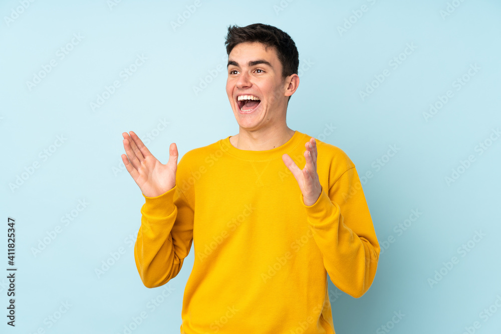 Teenager caucasian handsome man isolated on purple background with surprise facial expression Teenager caucasian handsome man isolated on purple background with surprise facial expression