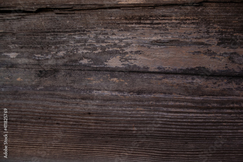 weathered dark wood background with texture. Texture of brown and grey old wood. Wide burned board texture close-up. a wooden surface.