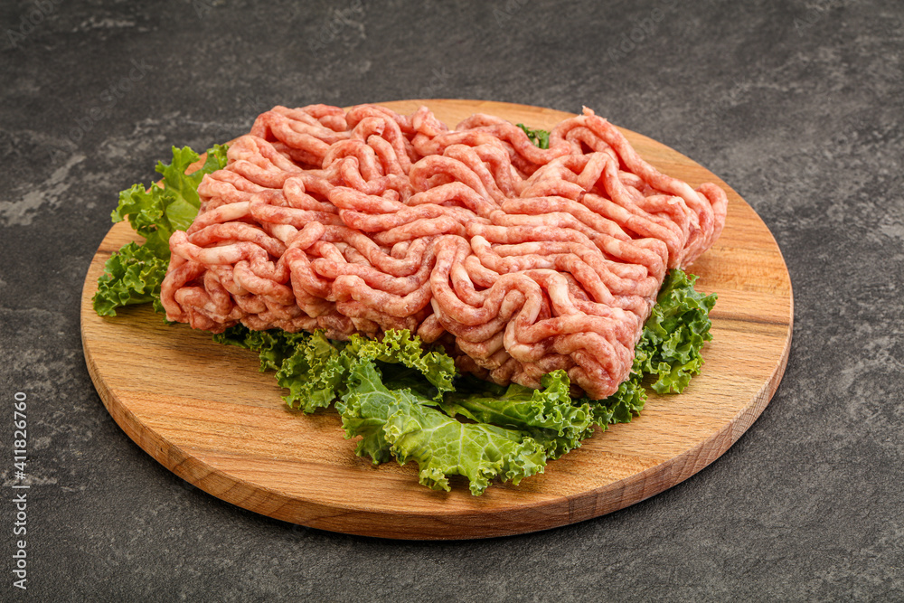 Raw pork minced meat over board Raw pork minced meat over board